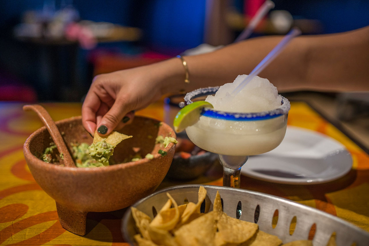 Sabor Woman Enjoying Guacamole and Margaritas