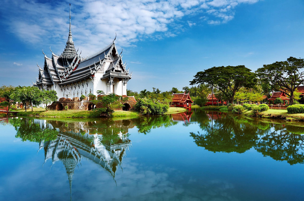The Sanphet Prasat Palace with reflections along the water in the Ancient City of Bangkok, Thailand