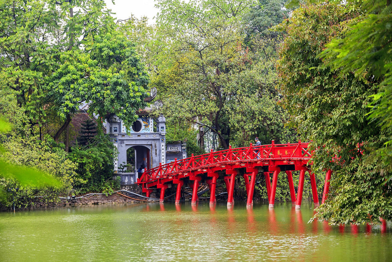 The red Huc Bridge in Hoan Kiem Lake, Hanoi, Vietnam