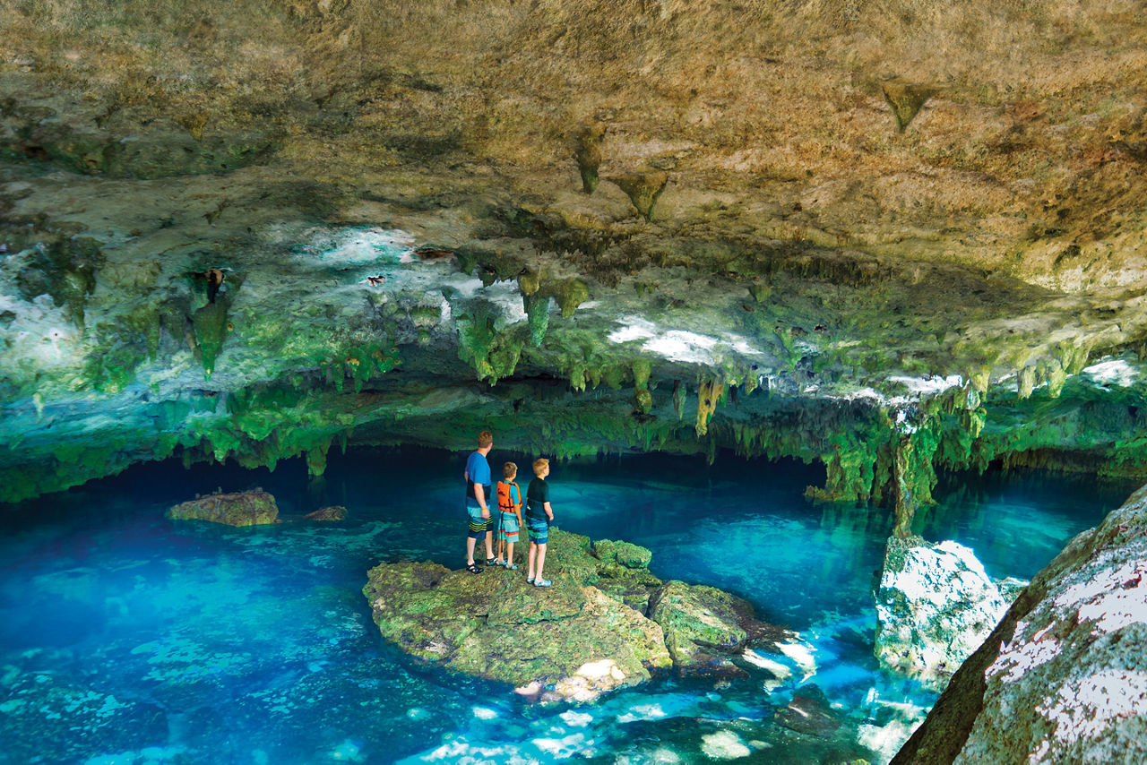 Family Exploring the Cenote Azul in Costa Maya