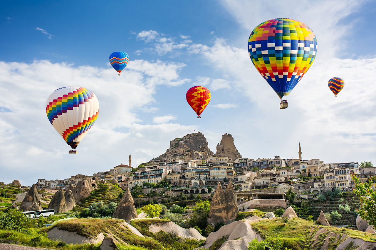 Hot air balloon ride & tourist attraction above Uchisar Castle. Turkey.