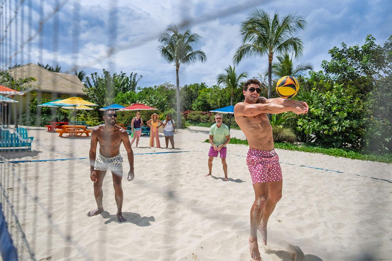 Friends playing beach volleyball at CocoCay