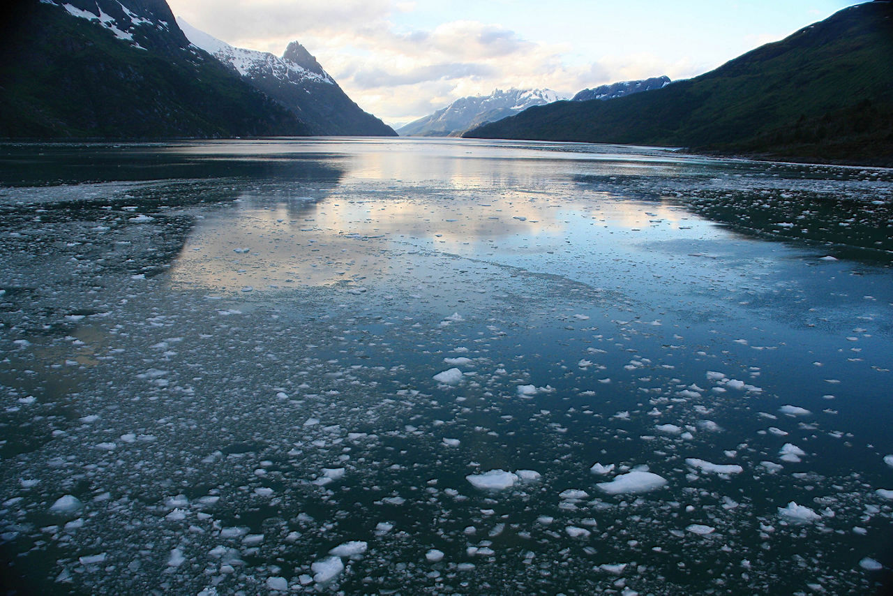 Abstract, brash ice forming at sundown in calm glacier bay, Strait of Magellan, Patagonia, Chile