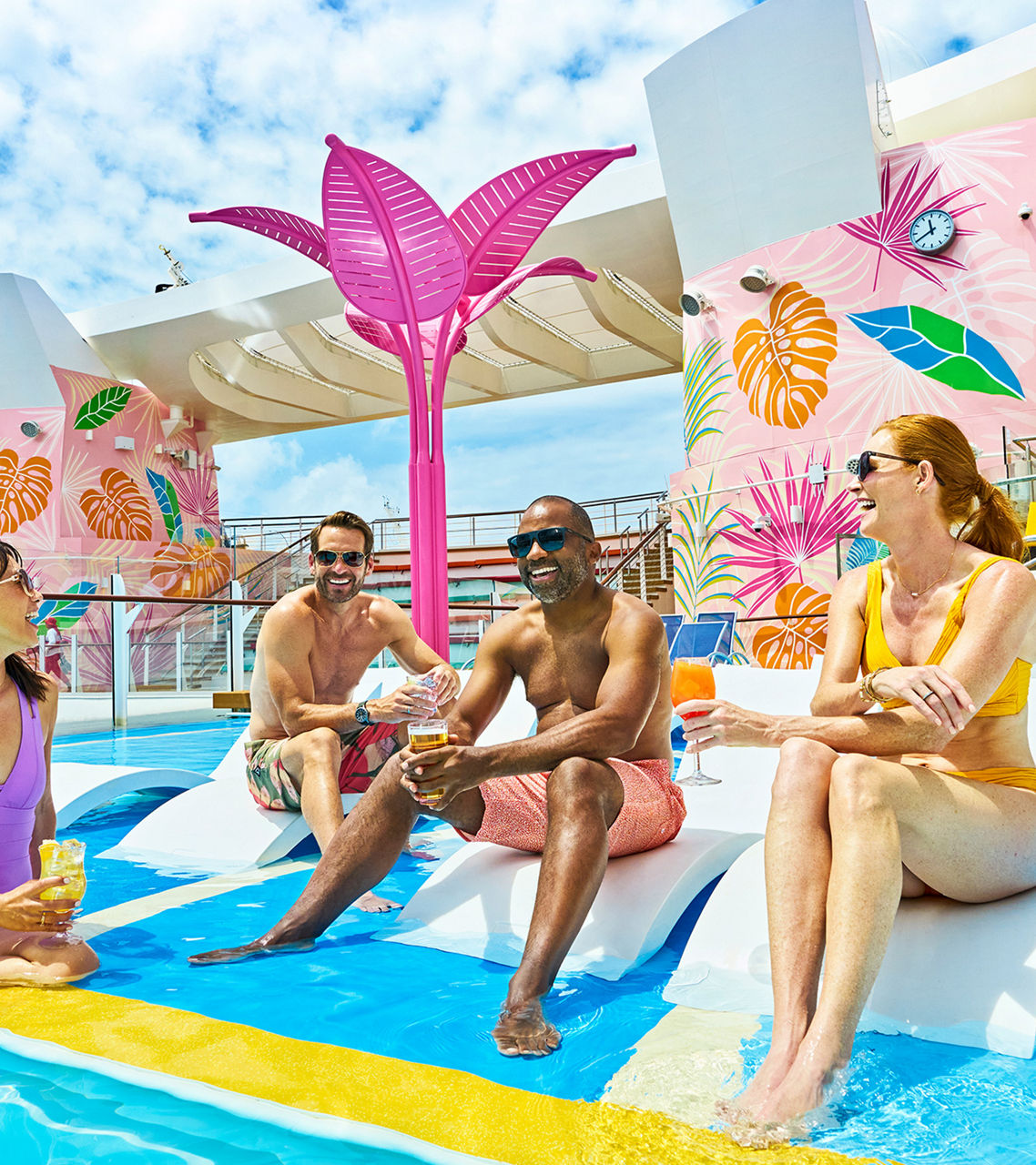 Friends hanging out at the pool deck drinking on Wonder of the Seas