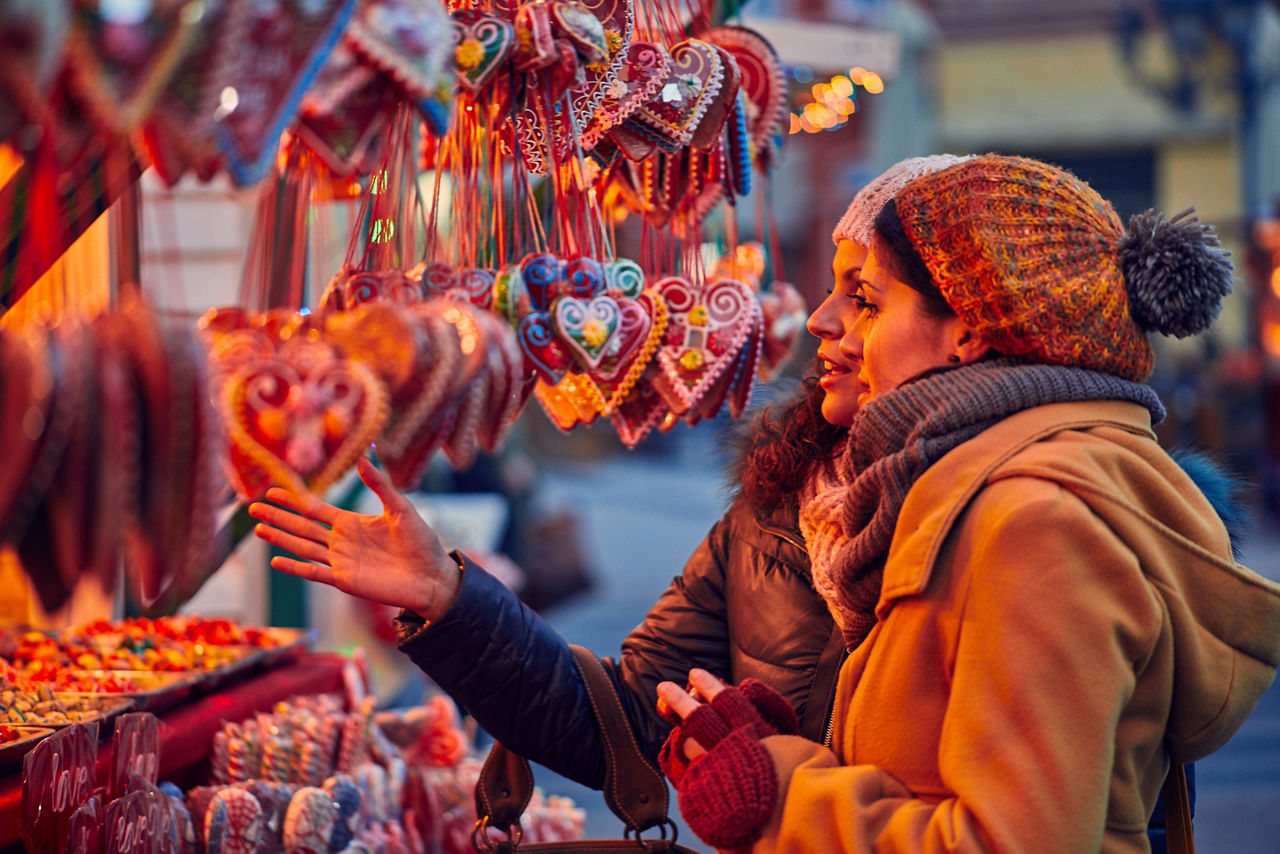 Friends shopping for candles in a street market. World Cruise